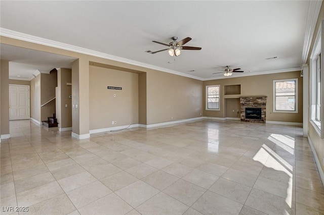 unfurnished living room featuring a healthy amount of sunlight and baseboards
