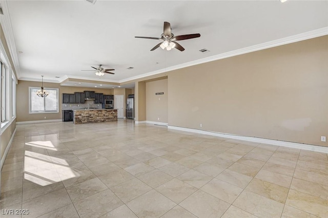 unfurnished living room featuring baseboards, visible vents, and crown molding