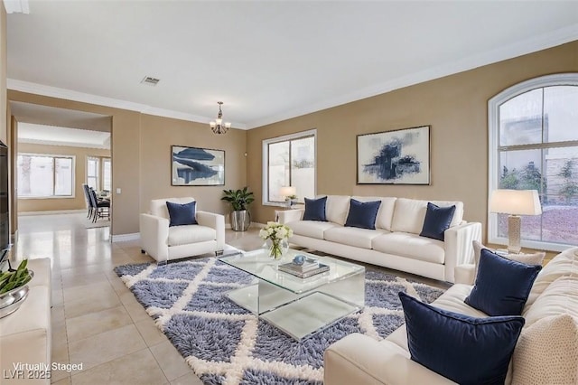 living area with light tile patterned floors, baseboards, visible vents, ornamental molding, and a notable chandelier
