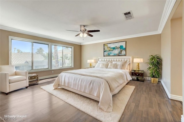bedroom with ornamental molding, visible vents, baseboards, and wood finished floors
