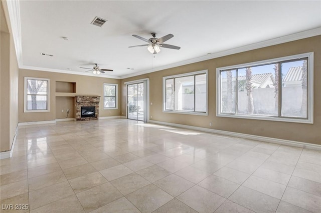 unfurnished living room with ornamental molding, a fireplace, visible vents, and baseboards