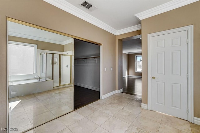 interior space featuring visible vents, crown molding, and baseboards