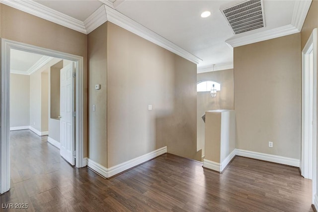 corridor with dark wood-type flooring, an upstairs landing, visible vents, baseboards, and ornamental molding
