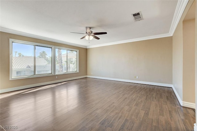 empty room featuring dark wood finished floors, visible vents, ornamental molding, a ceiling fan, and baseboards