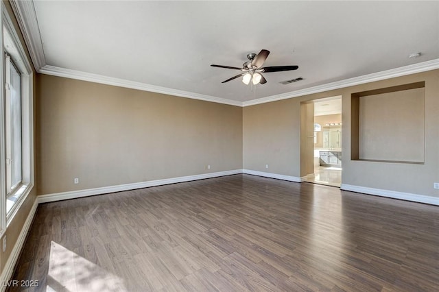 unfurnished room featuring wood finished floors, visible vents, and baseboards