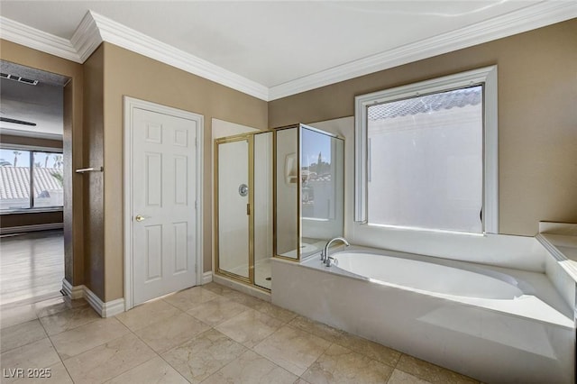 bathroom featuring a garden tub, ornamental molding, a shower stall, and baseboards