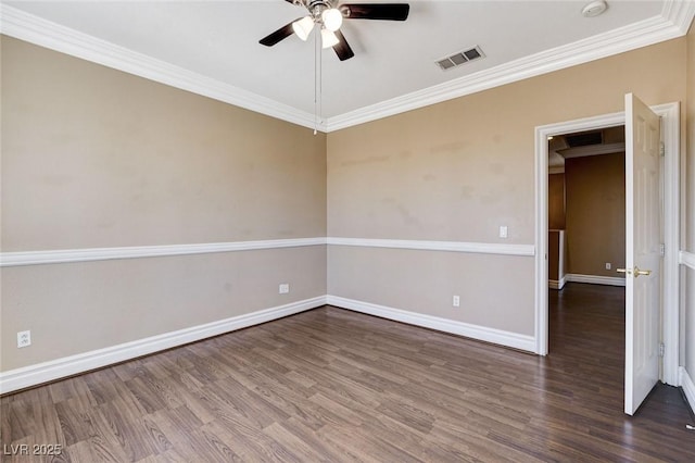 empty room with ceiling fan, visible vents, baseboards, ornamental molding, and dark wood finished floors