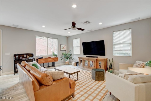 living area with recessed lighting, visible vents, ceiling fan, light wood-type flooring, and baseboards