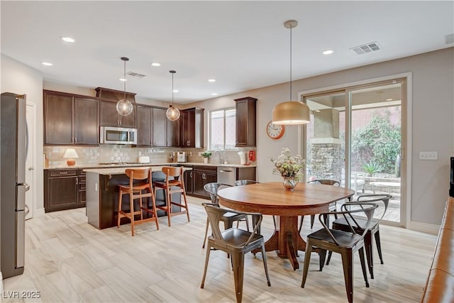 dining room featuring baseboards, visible vents, and recessed lighting