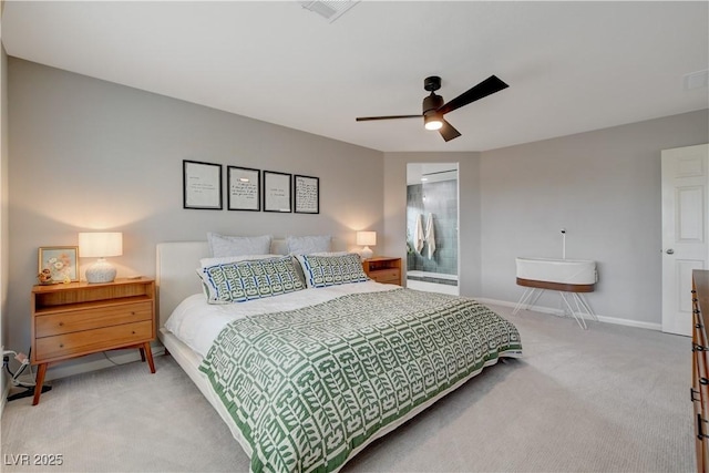 carpeted bedroom featuring ceiling fan, visible vents, baseboards, and ensuite bathroom