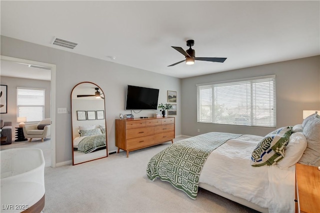 carpeted bedroom with ceiling fan, multiple windows, visible vents, and baseboards