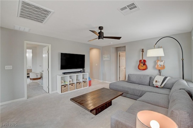 living area with visible vents, ceiling fan, light carpet, and baseboards