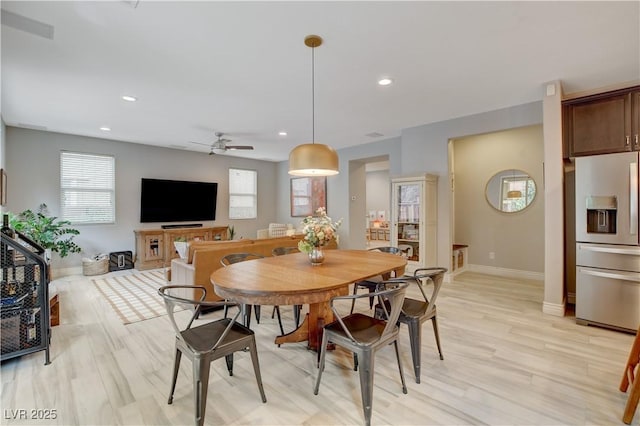 dining space with a wealth of natural light, light wood-style flooring, and recessed lighting