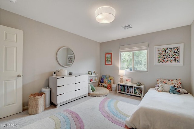 bedroom featuring visible vents and light colored carpet