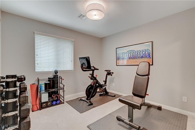 exercise room featuring carpet floors, baseboards, and visible vents