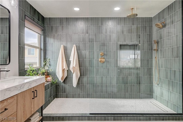 full bathroom featuring a walk in shower, vanity, and recessed lighting