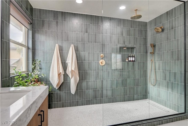 bathroom featuring recessed lighting, vanity, and walk in shower