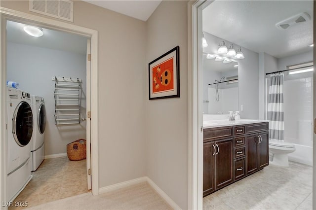 bathroom with visible vents, toilet, independent washer and dryer, tile patterned flooring, and vanity