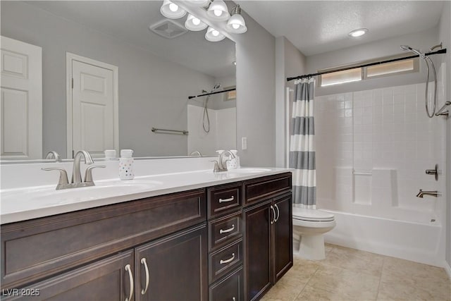 bathroom with double vanity, shower / bath combo, a sink, and tile patterned floors