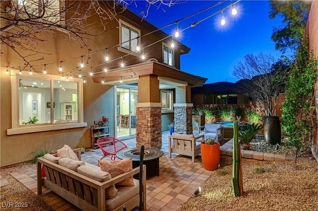 view of patio / terrace featuring an outdoor living space with a fire pit