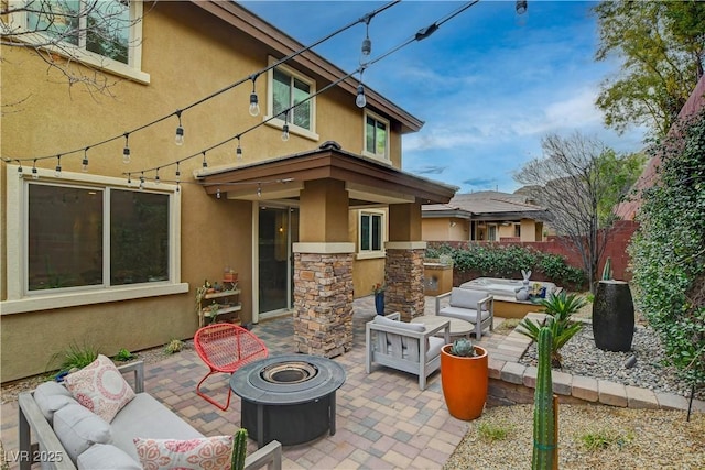 view of patio / terrace with an outdoor living space with a fire pit and fence