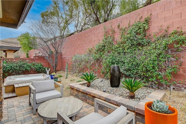 view of patio featuring a fenced backyard and an outdoor hot tub