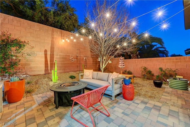 view of patio / terrace featuring a fenced backyard and an outdoor living space with a fire pit