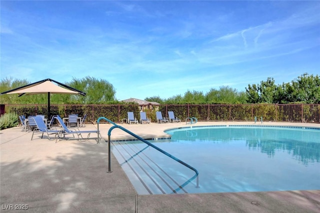 pool featuring a patio area and fence