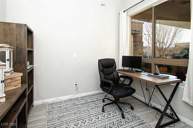 office area featuring light wood-style floors and baseboards