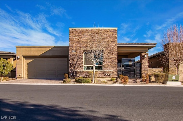 view of front of house featuring stone siding, driveway, an attached garage, and stucco siding