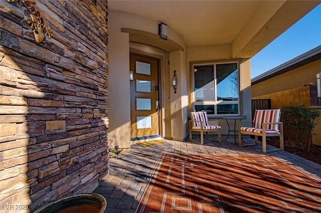 view of exterior entry featuring stone siding