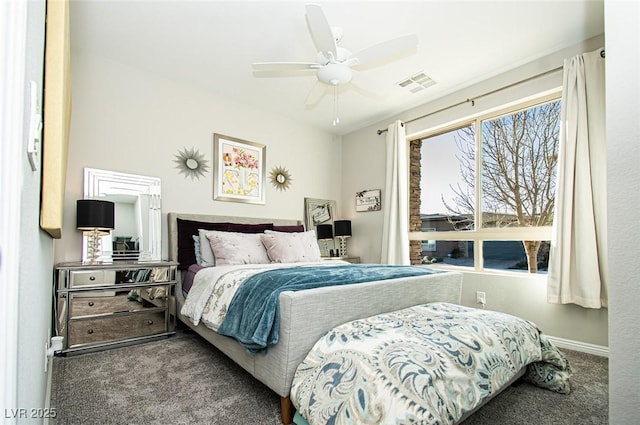 carpeted bedroom with baseboards, visible vents, and a ceiling fan