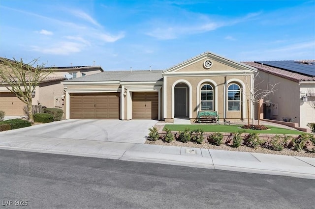 view of front of house featuring concrete driveway, an attached garage, a tiled roof, and stucco siding