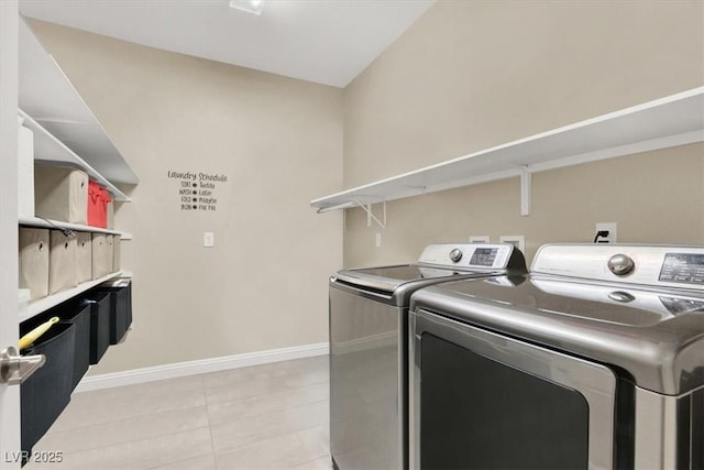 laundry area featuring laundry area, washer and clothes dryer, and baseboards