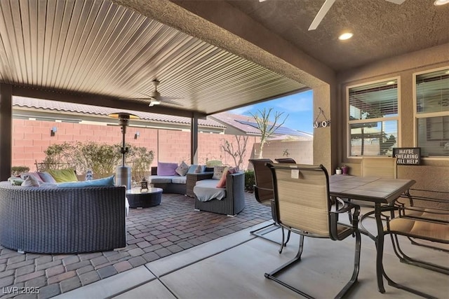 view of patio with outdoor dining area, outdoor lounge area, a fenced backyard, and a ceiling fan