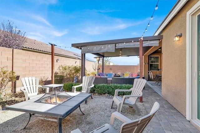 view of patio with an outdoor living space with a fire pit and fence