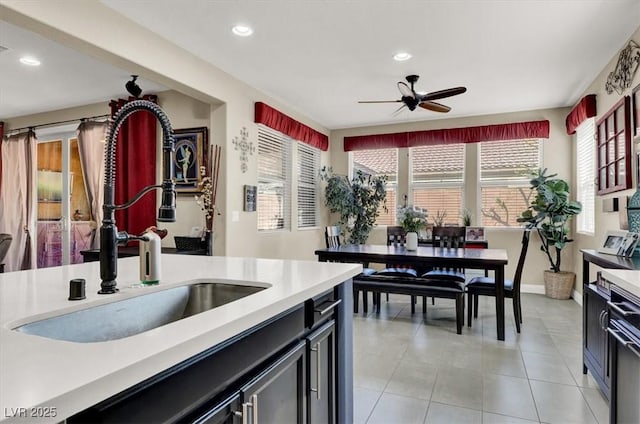 kitchen featuring recessed lighting, light countertops, a sink, and light tile patterned flooring