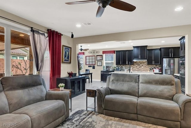 living room with light tile patterned floors, baseboards, visible vents, a ceiling fan, and recessed lighting