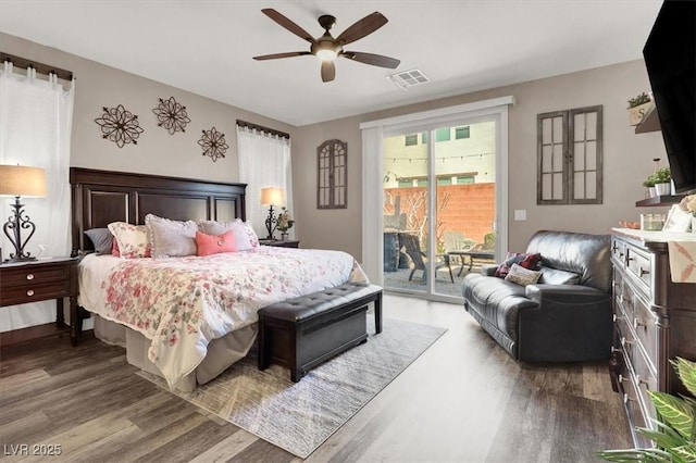 bedroom featuring a ceiling fan, access to outside, visible vents, and wood finished floors