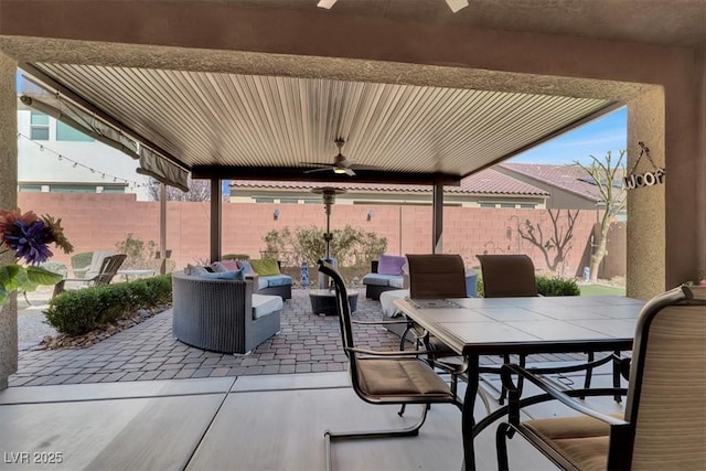 view of patio featuring outdoor dining space, an outdoor living space, a fenced backyard, and a ceiling fan