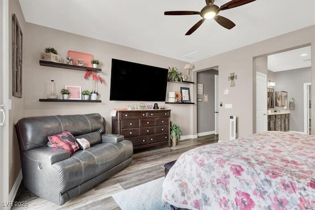 bedroom featuring ceiling fan, wood finished floors, connected bathroom, and baseboards