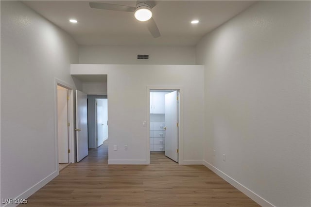 unfurnished bedroom with light wood-style floors, visible vents, baseboards, and a ceiling fan