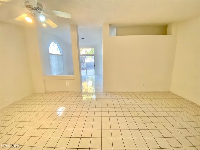 empty room featuring ceiling fan and light tile patterned flooring