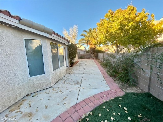 view of home's exterior featuring a patio area, a fenced backyard, and stucco siding