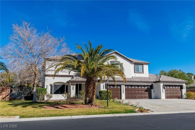 view of front facade with driveway, a garage, a front yard, and stucco siding