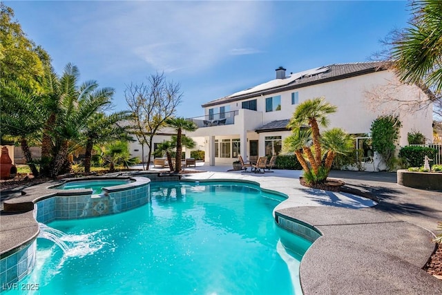 view of pool featuring a patio area and a pool with connected hot tub