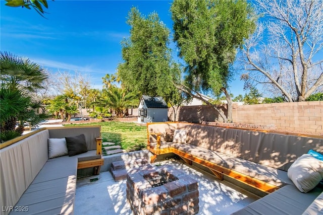 deck featuring an outbuilding, a patio, a fenced backyard, a storage shed, and an outdoor hangout area