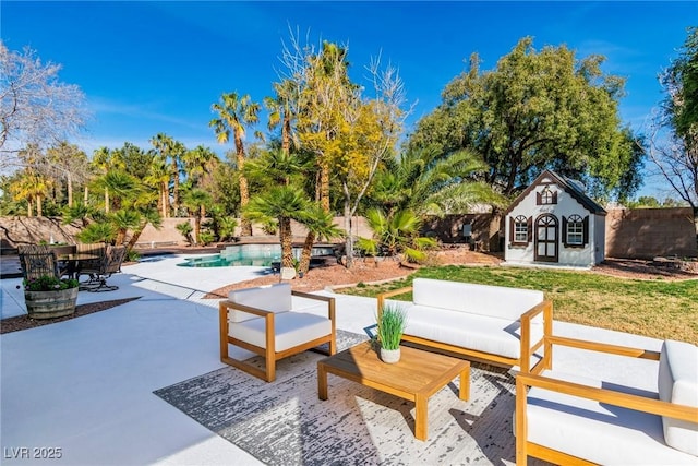 view of patio with a fenced in pool, an outbuilding, a fenced backyard, and an outdoor hangout area