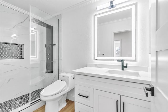 bathroom with a marble finish shower, toilet, ornamental molding, wood finished floors, and vanity