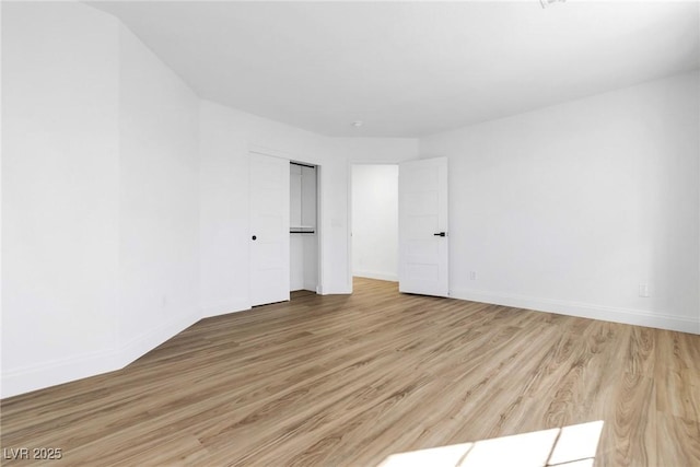 unfurnished room featuring light wood-type flooring and baseboards